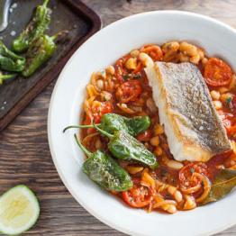 Pan-fried pollock with padron peppers, tomatoes and white beans