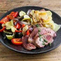 Roast lamb and mint sauce with boulangère potatoes and rosemary roast veg