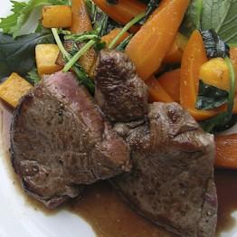 Roasted venison haunch with red wine and rosemary gravy