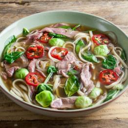 Winter beef pho with sprout leaves, shallots and udon noodles